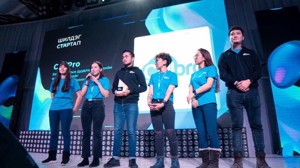 CallPro team presenting on stage at an event