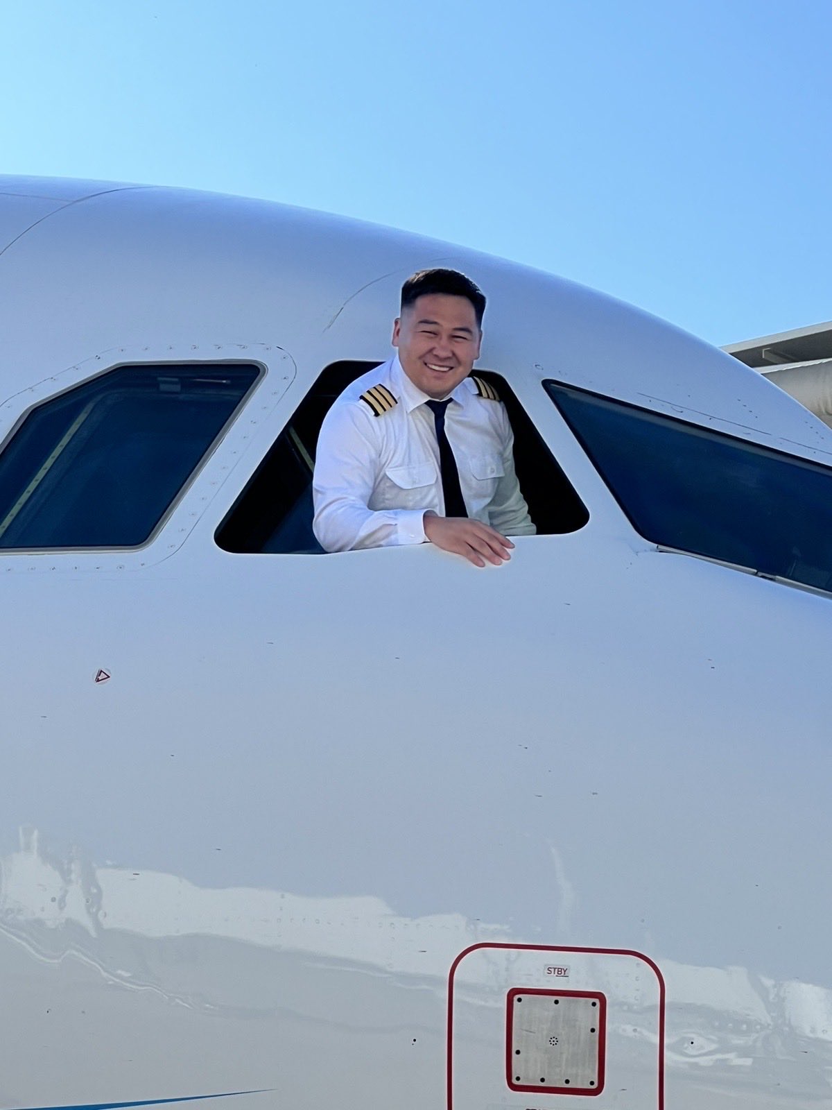 Pilot leaning out of an aircraft cockpit window