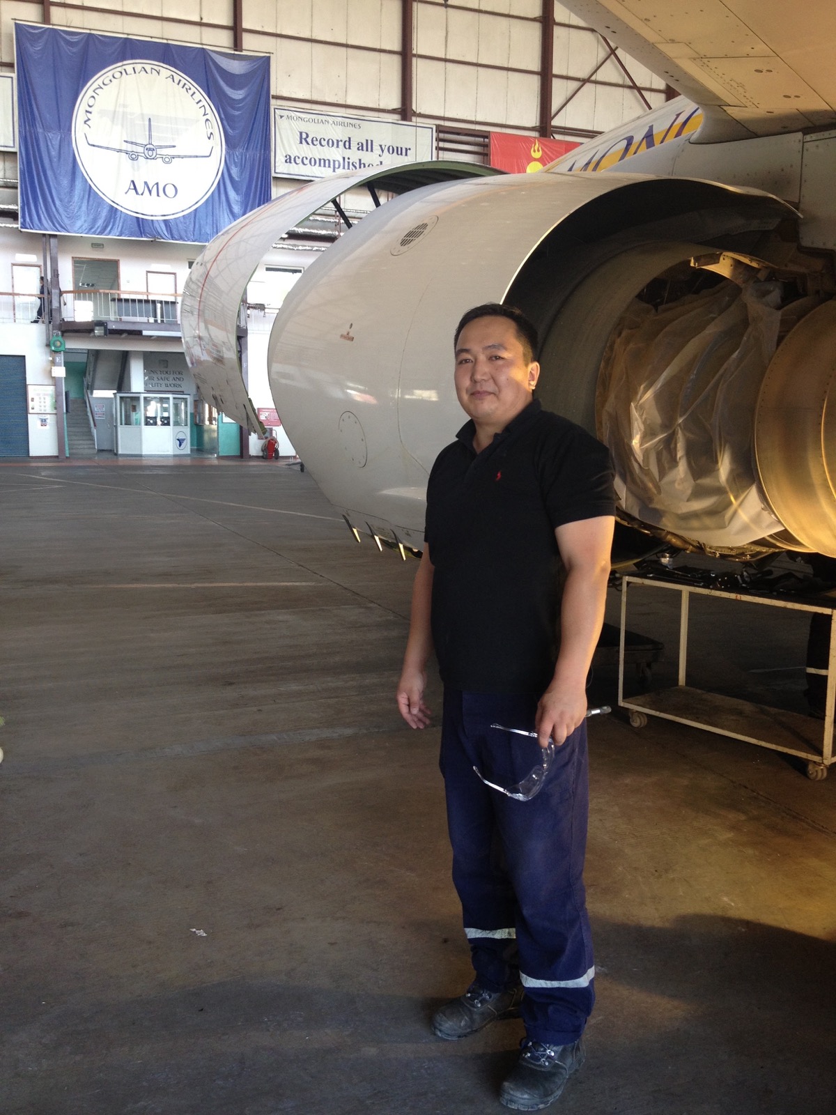 Maintenance worker beside an aircraft engine